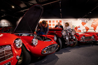 Visitors Looking Under Bonnet At Haynes Motor Museum