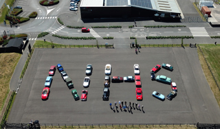 Aerial View Of NHS Spelt Out With Cars From Haynes Motor Museum. Photo Credit Glenn Lucas