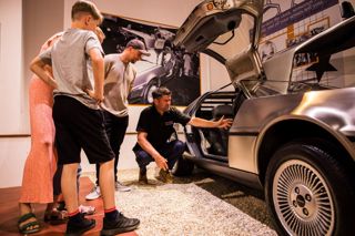 Visitors Looking At Delorean DMC At Haynes Motor Museum