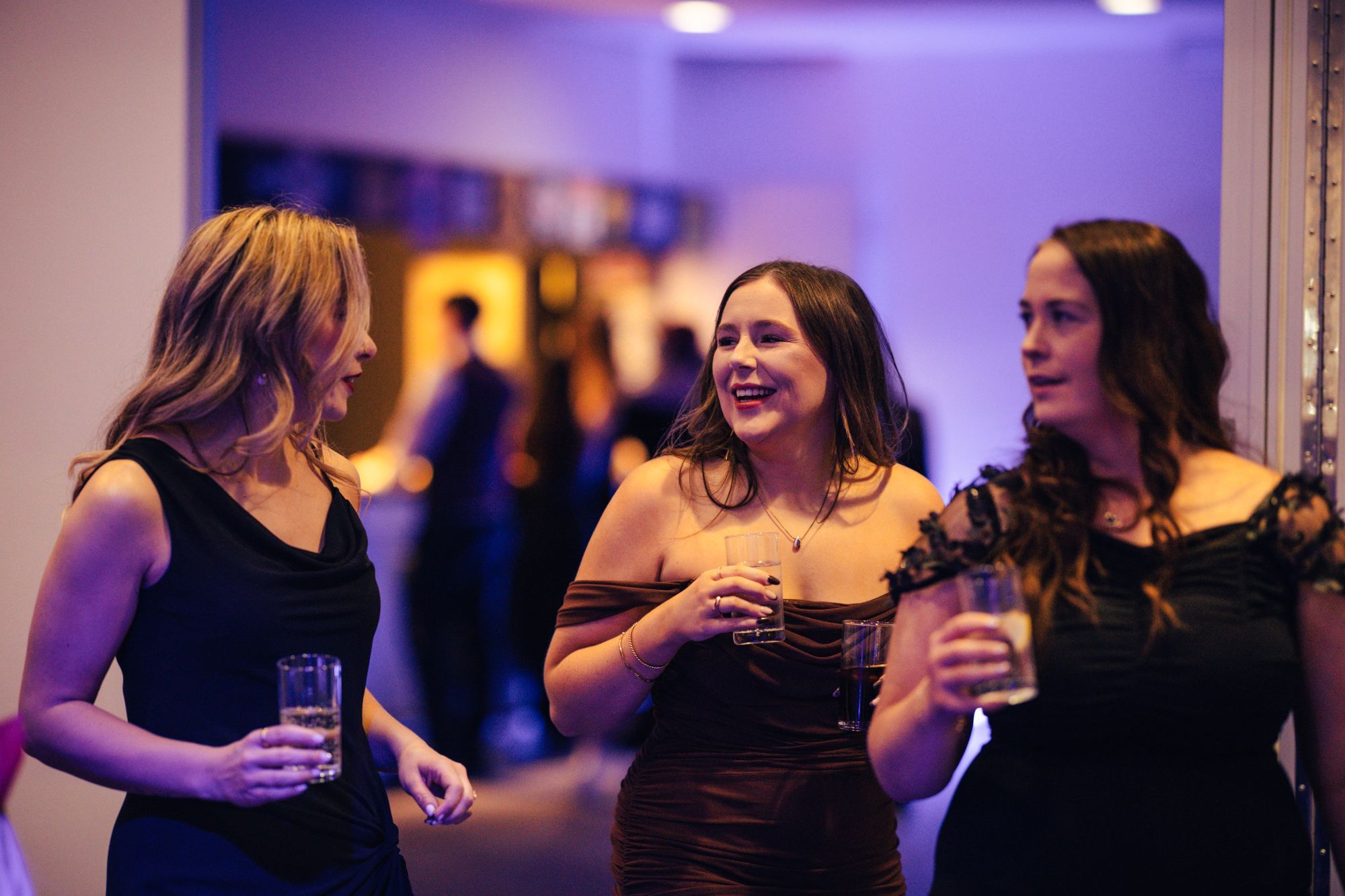 Guests With Drinks At Christmas Party