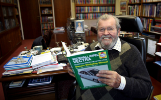 John Haynes OBE, Founder Of Haynes Motor Museum, With A Haynes Manual